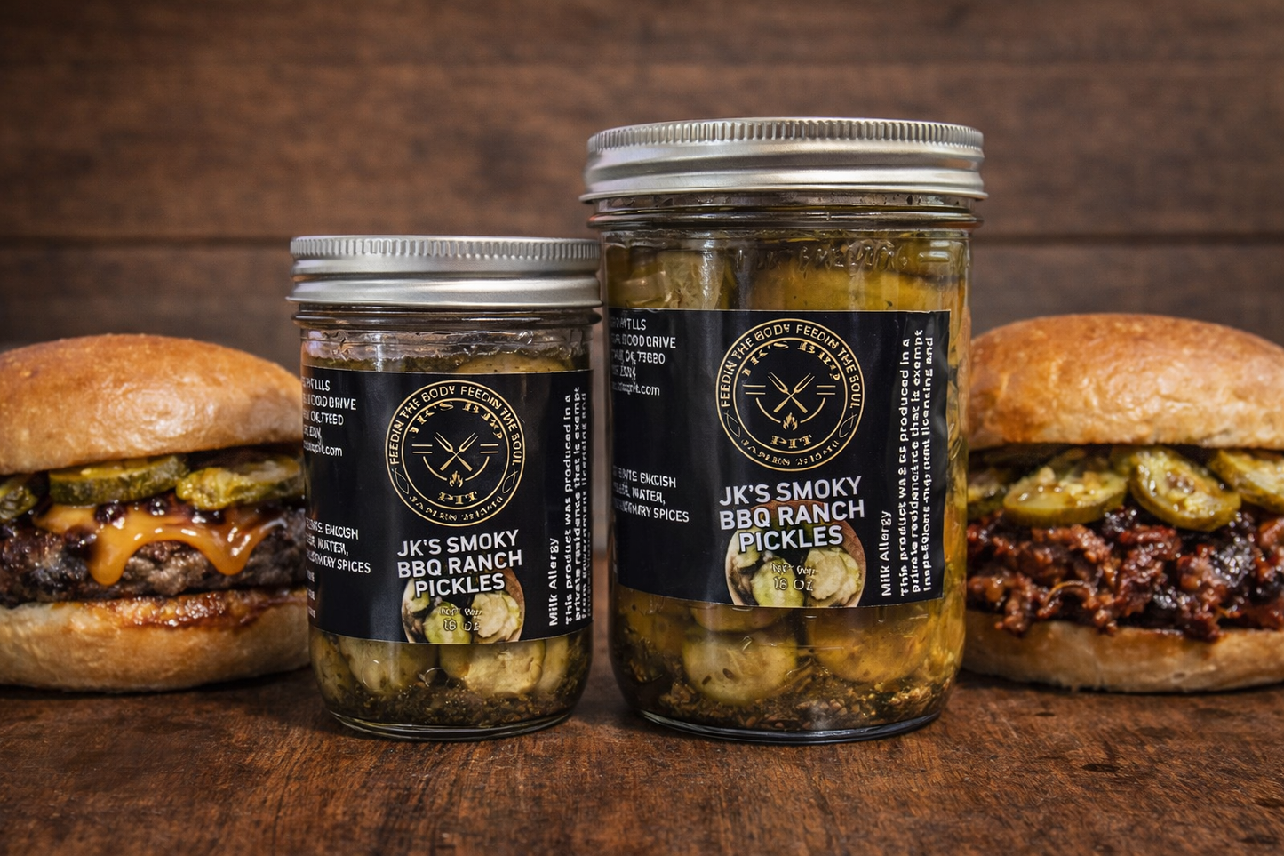 JK’s BBQ Pit Smoked BBQ Ranch Pickles in a glass jar on a rustic wooden background with BBQ burgers and smoked meats.
