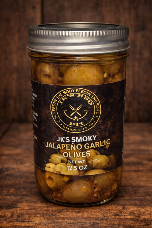 JK's BBQ Pit Smoky Jalapeño Garlic Olives in a 12.5 oz mason jar with black and gold label on a rustic wooden background