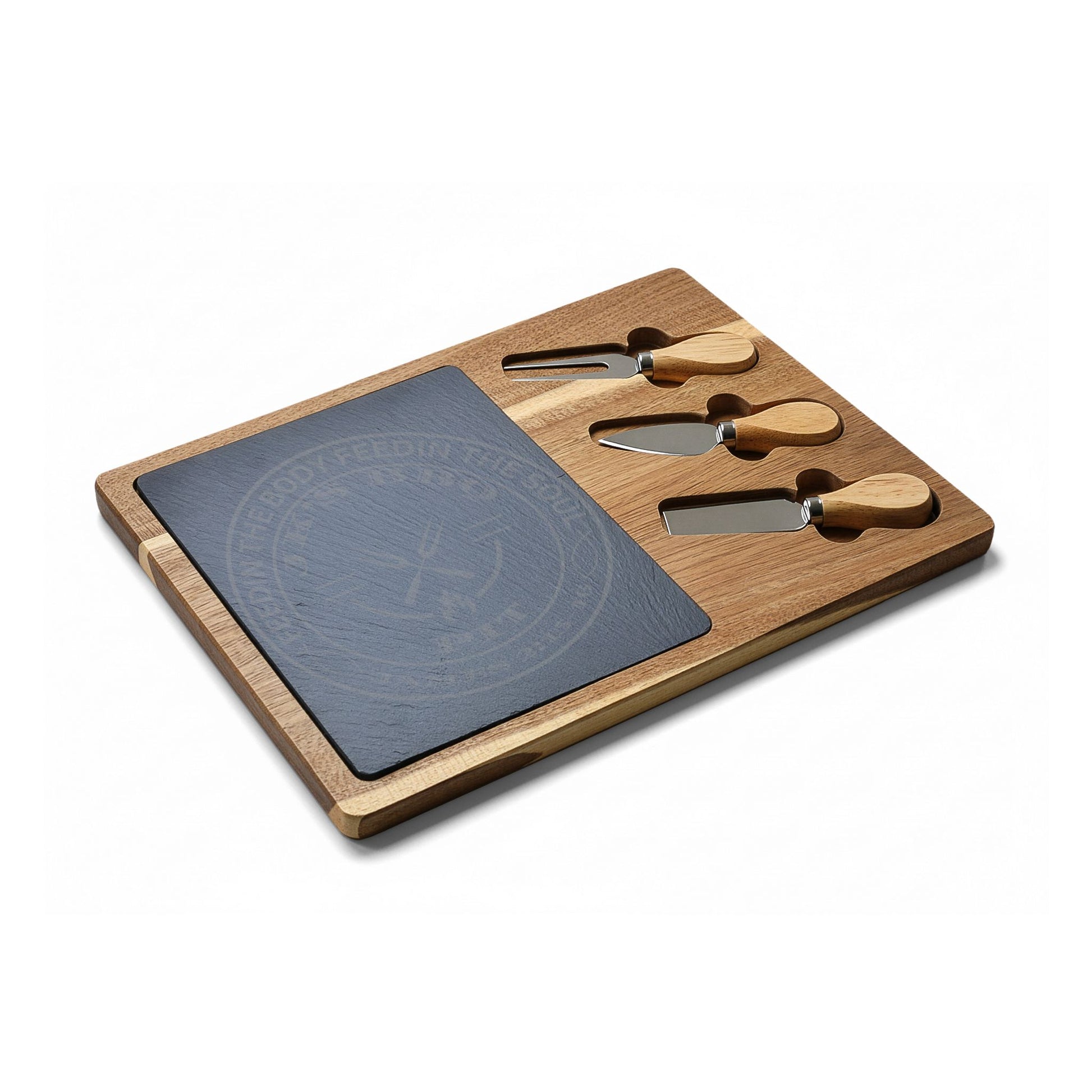 Wooden cheese board set with slate surface and four utensils on a white background