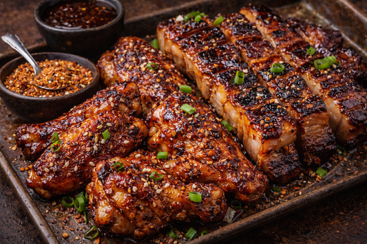 Caramelized Korean BBQ chicken wings and pork belly coated with JK’s Korean Firecracker Seasoning