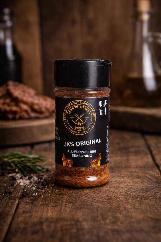 JK’s Original All-Purpose BBQ Seasoning – small batch smoked BBQ rub on wooden background with rosemary and peppercorns
