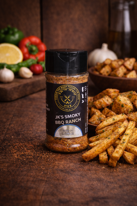 JK’s Smoky BBQ Ranch seasoning bottle on rustic wooden table with seasoned fries and smoked potatoes
