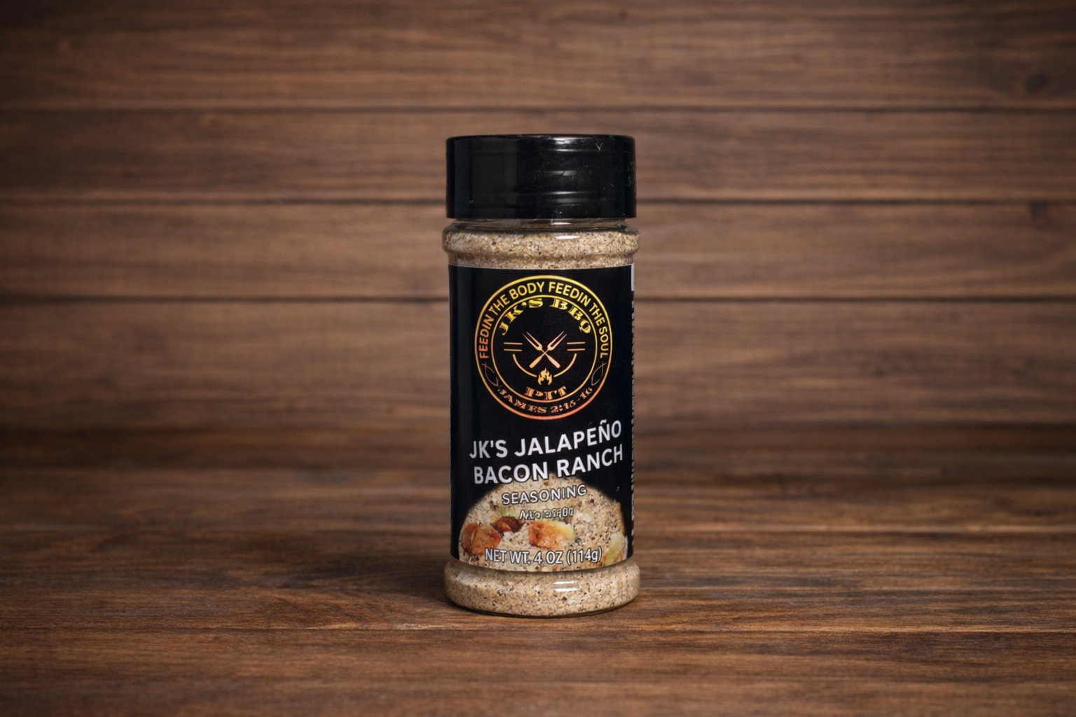 JK’s Jalapeño Bacon Ranch seasoning 4 oz bottle on wooden background, spicy smoky ranch BBQ seasoning for burgers, fries, and grilling