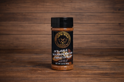 JK’s Maple Bourbon Bacon Chipotle rub 3 oz bottle on wooden background, sweet smoky BBQ seasoning for burgers, bacon, and grilling