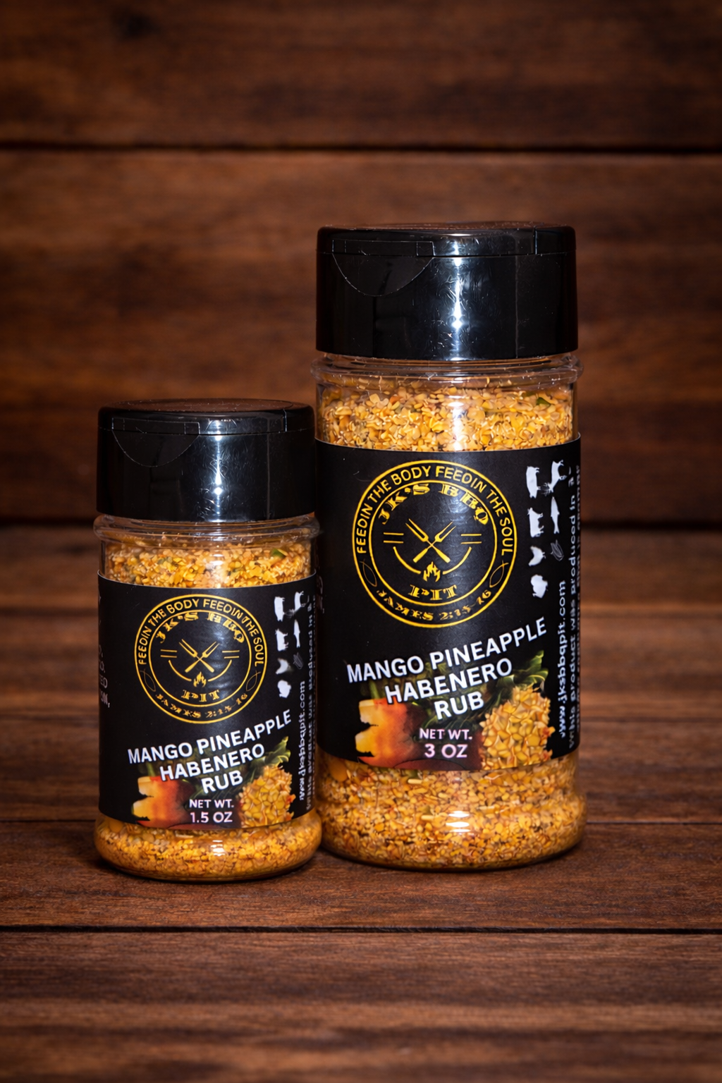 JK’s BBQ Pit Mango Pineapple Habanero Rub seasoning bottles showing 1.5 oz and 3 oz size comparison on rustic wooden background.
