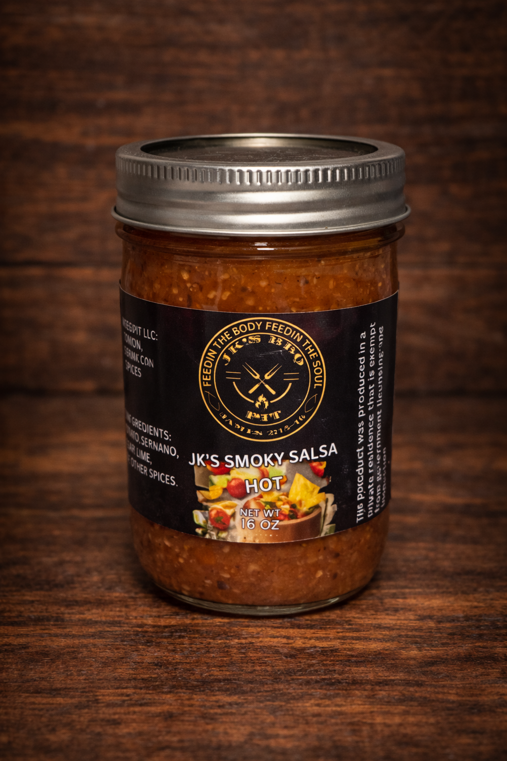 JK's BBQ Pit Smoky Salsa Hot 16 oz jar on rustic wooden background small batch smoked tomato hot salsa in mason jar