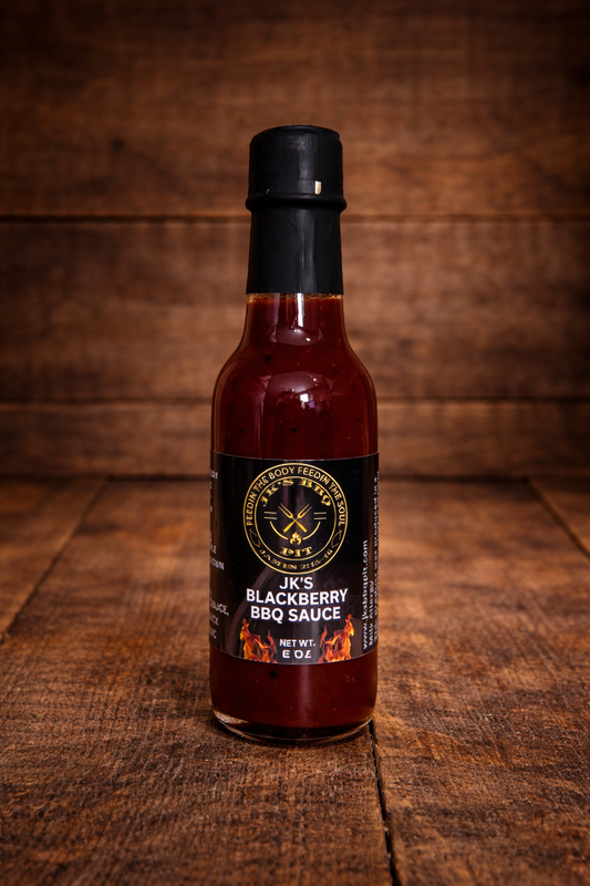 Bottle of JK’s Blackberry BBQ Sauce on rustic wooden background – small batch BBQ sauce by JK’s BBQ Pit