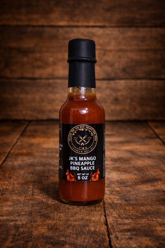 Bottle of JK’s Mango Pineapple BBQ Sauce on rustic wooden table background – sweet tropical BBQ sauce by JK’s BBQ Pit.