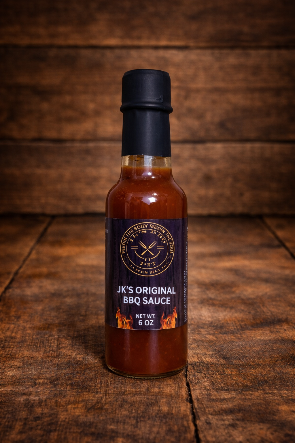 JK’s Original BBQ Sauce bottle on rustic wooden table background – classic pitmaster BBQ sauce by JK’s BBQ Pit.