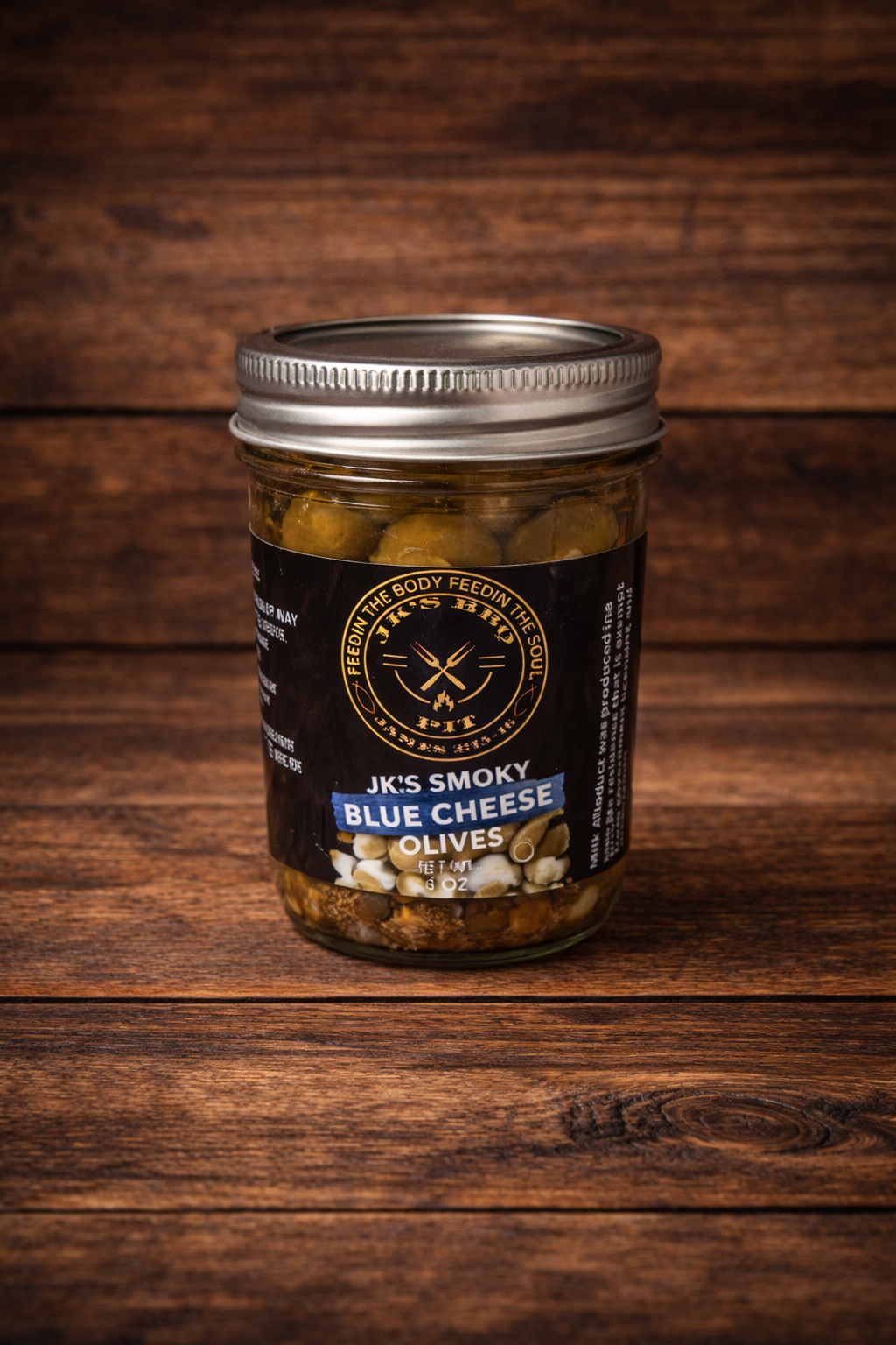 JK’s Smoky Blue Cheese Olives jar on rustic wooden background
