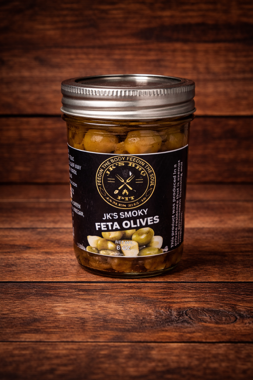 JK’s Smoky Feta Olives jar on rustic wooden background