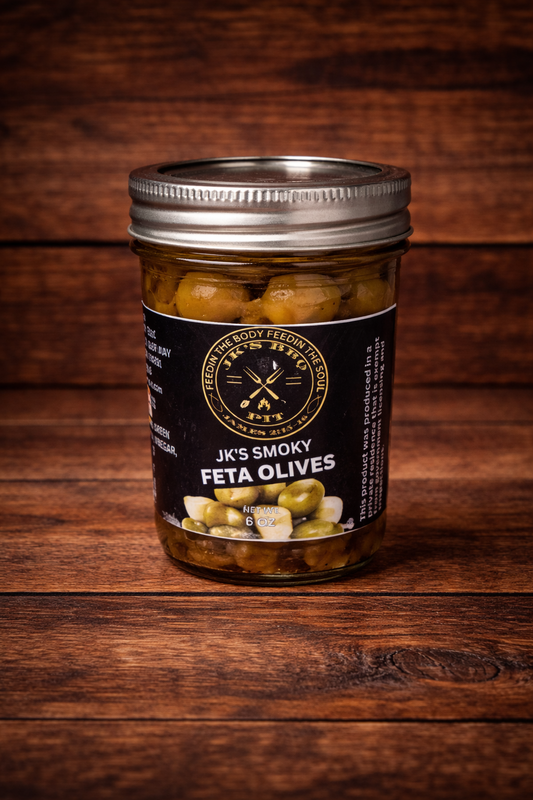 JK’s Smoky Feta Olives jar on rustic wooden background