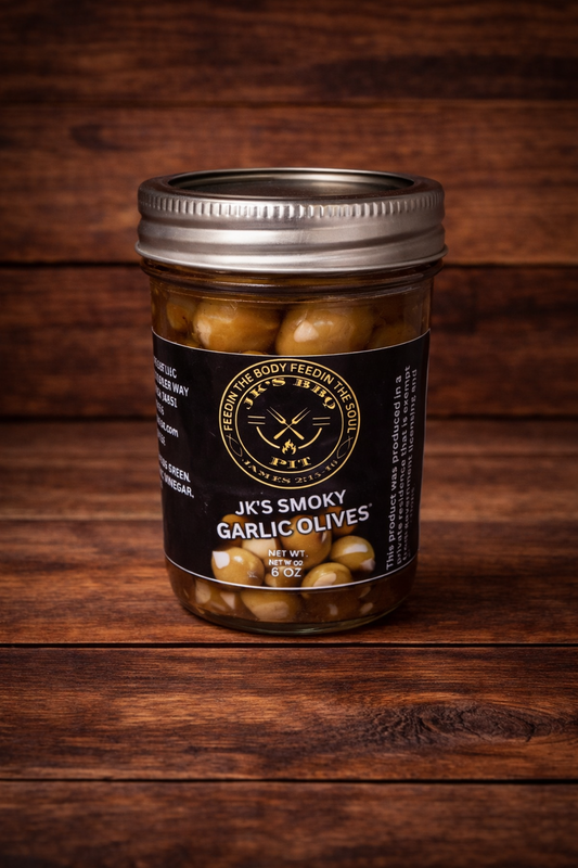 JK’s Smoky Garlic Olives jar on rustic wooden background
