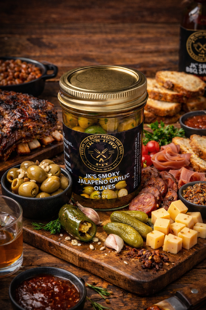 Smoked Jalapeño Garlic Olives by JK’s BBQ Pit with BBQ charcuterie board, smoked meats, cheeses, pickles and crackers on rustic wooden table