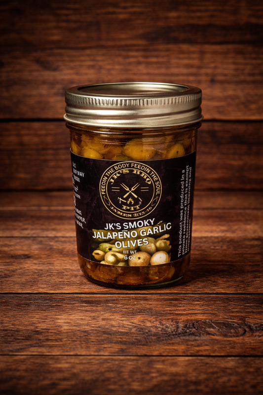 JK’s Smoky Jalapeño Garlic Olives jar on rustic wooden background