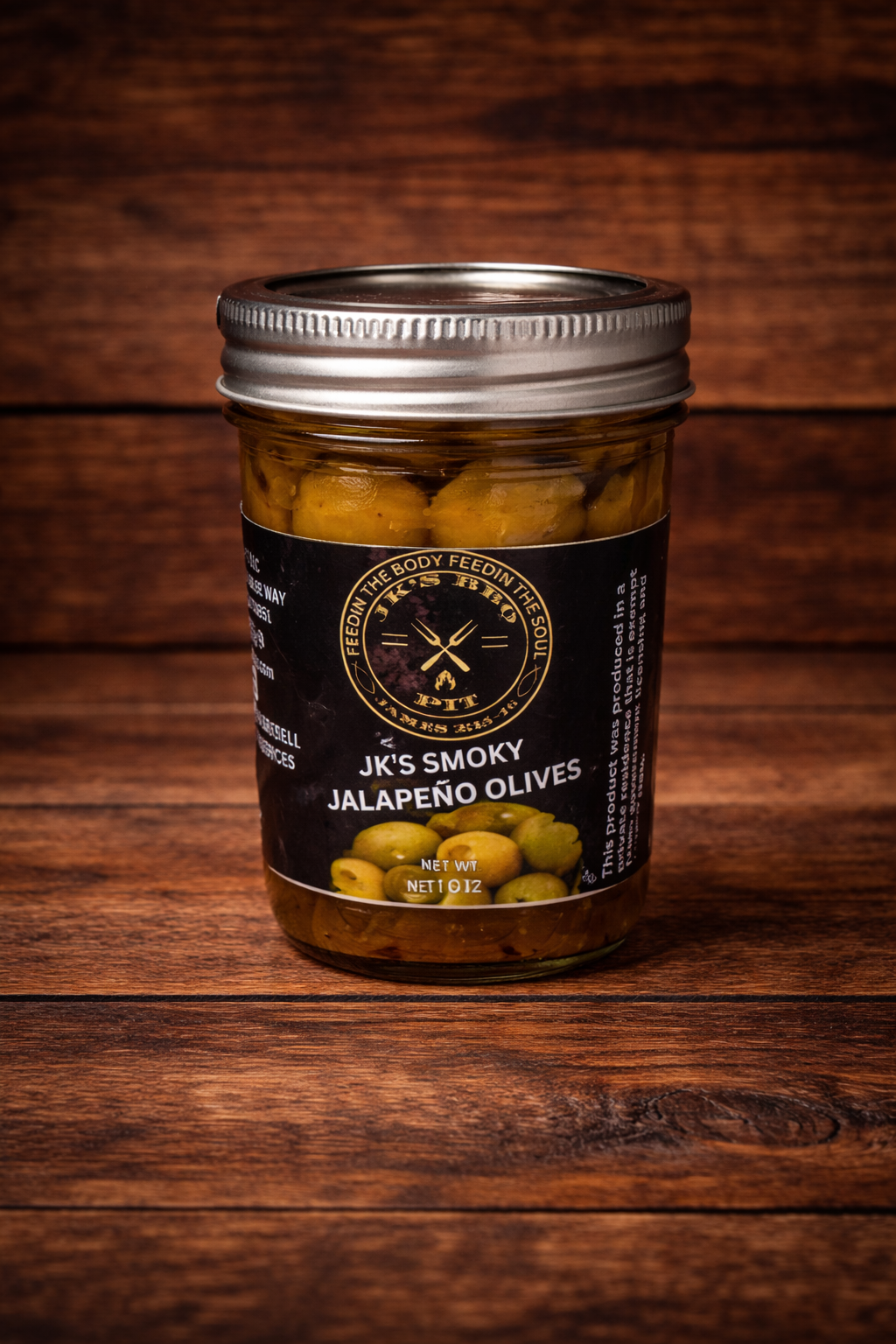 JK’s Smoky Jalapeño Olives jar on rustic wooden background