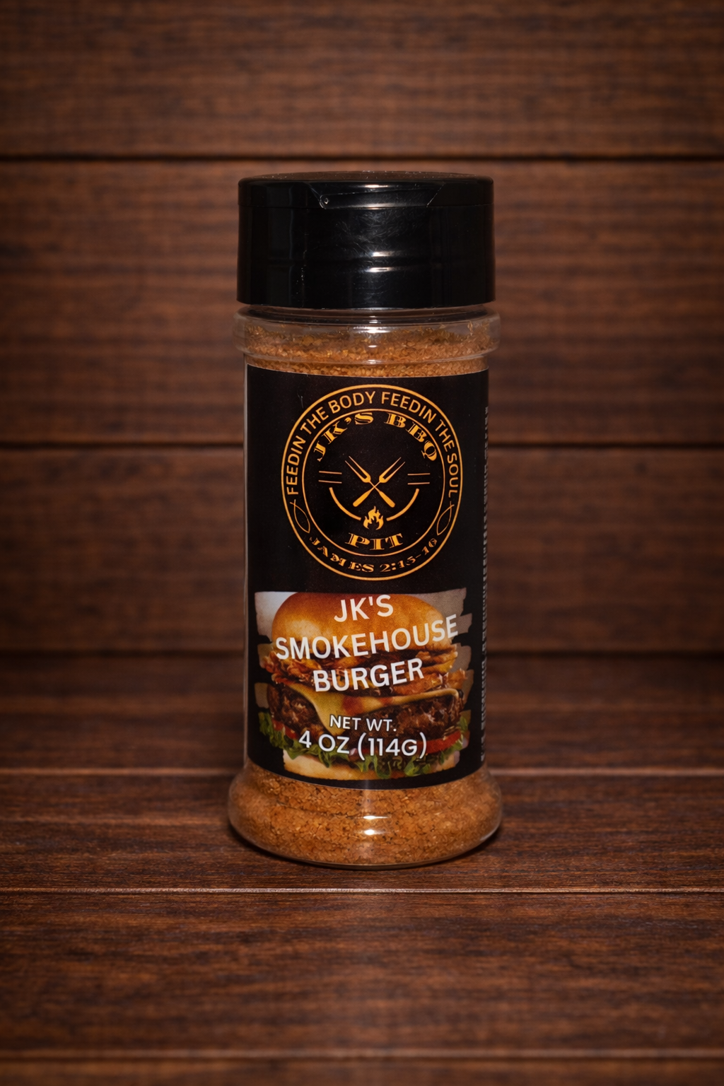 JK's Smokehouse Burger seasoning 4 oz bottle on dark rustic wooden table and wood wall background – smoky BBQ burger rub for smash burgers, grilled burgers, fries, and backyard grilling