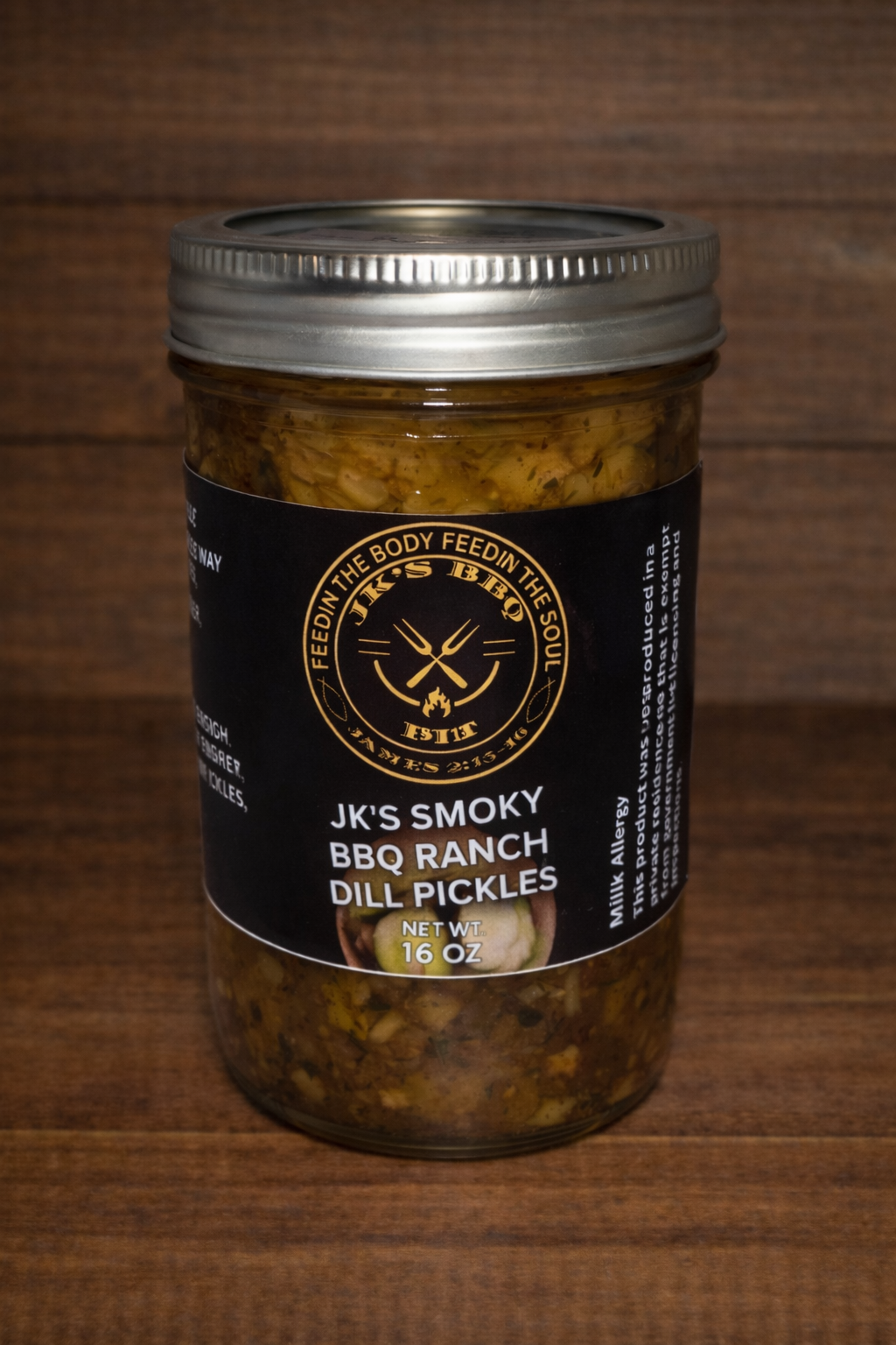 16 oz jar of JK's BBQ Pit BBQ Ranch Dill Pickles on rustic wooden background smoky ranch seasoned dill pickles