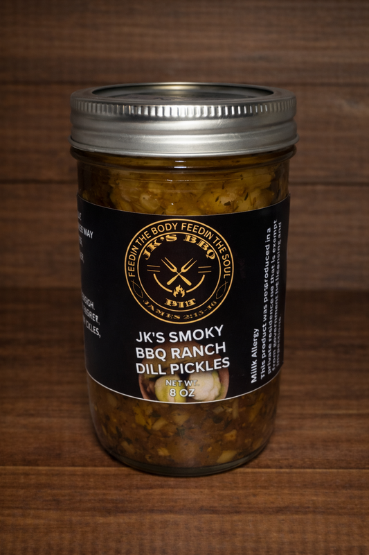 8 oz jar of JK's BBQ Pit BBQ Ranch Dill Pickles on rustic wooden background smoky ranch seasoned pickle slices