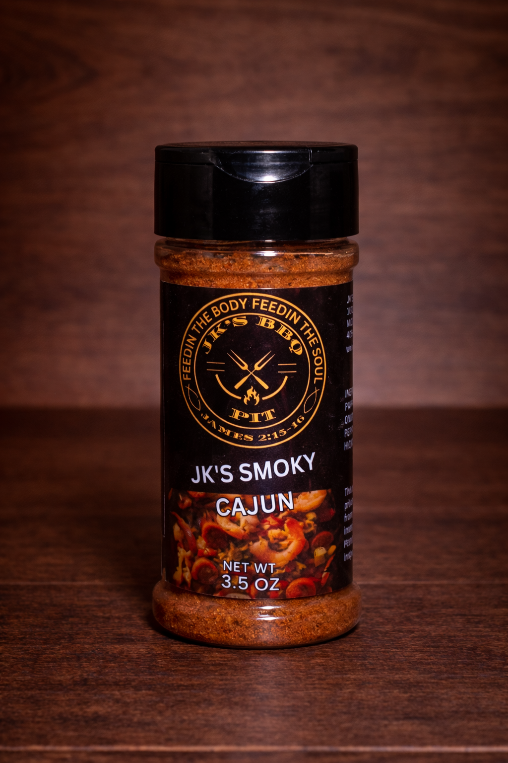 JK’s Smoky Cajun seasoning 3.5 oz bottle on wooden background with bold Cajun spice blend visible in clear jar