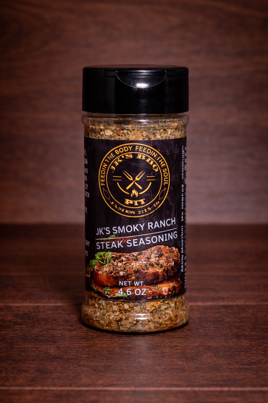 JK’s Smoky Ranch Steak Seasoning 4.5 oz bottle on wooden background with steak seasoning blend visible in clear jar
