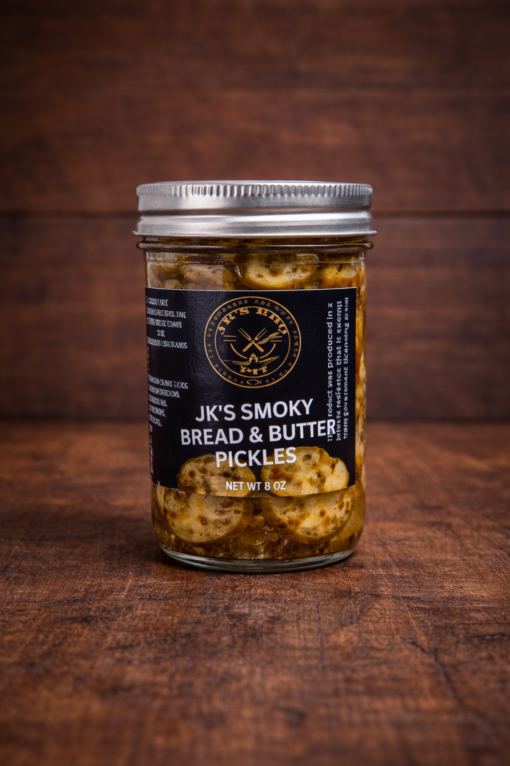 JK’s Smoky Sweet Heat Pickles 8 oz jar smoked bread and butter BBQ pickles on wooden background