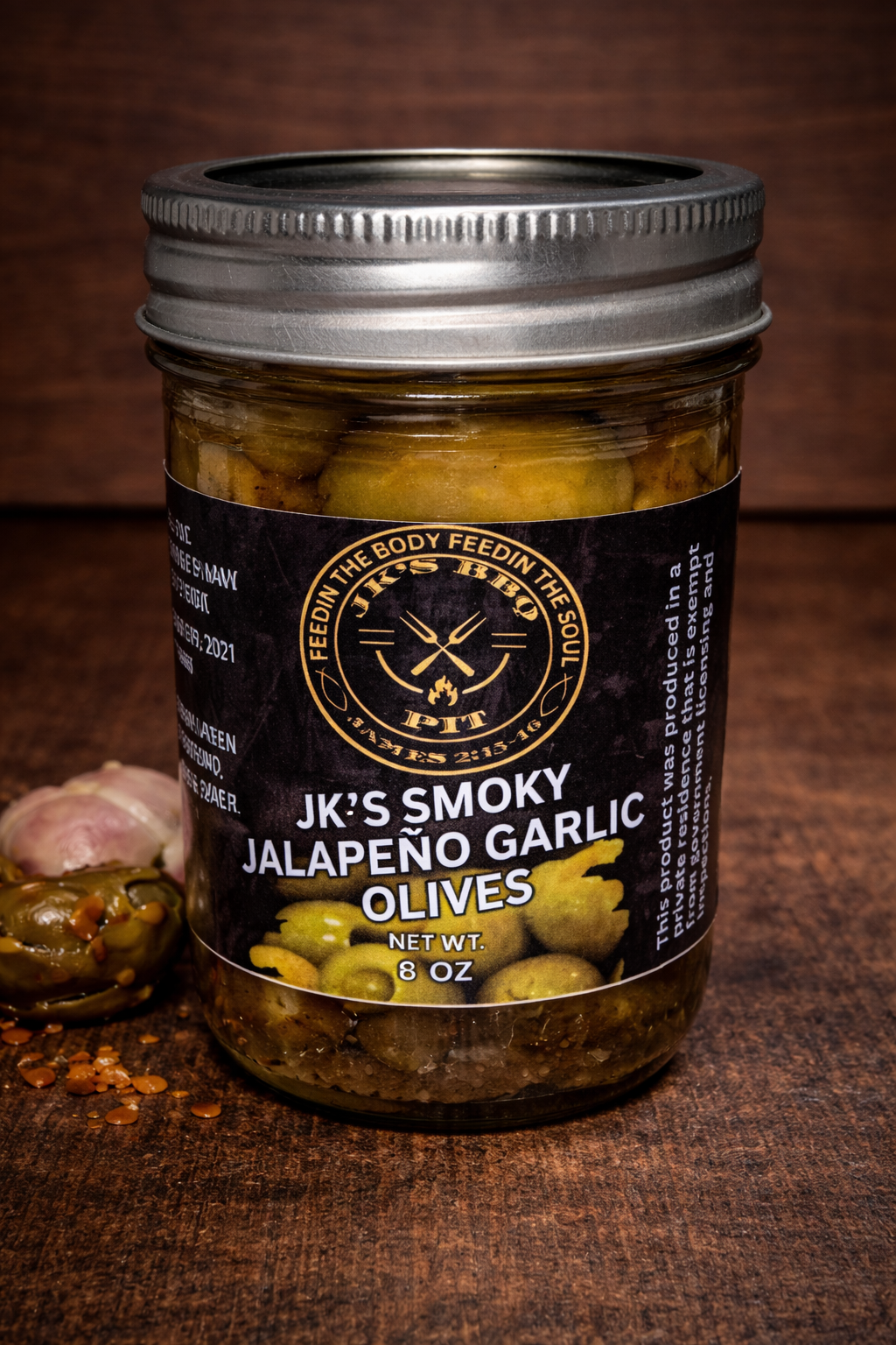 Smoked jalapeño garlic olives in glass jar with bold BBQ flavor by JK’s BBQ Pit
