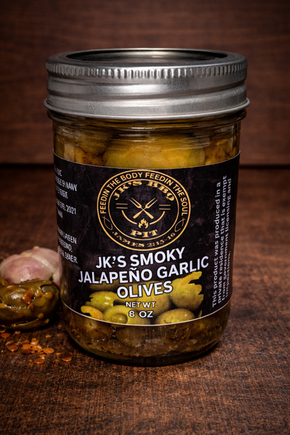 Smoked jalapeño garlic olives in glass jar with bold BBQ flavor by JK’s BBQ Pit